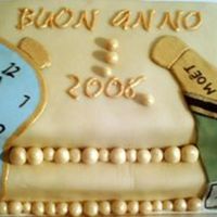 Dali New Year Choc cake covered with white choc plastic. Clock and bottle in fondant and then painted details. Writing in RI overpainted with gold luster...