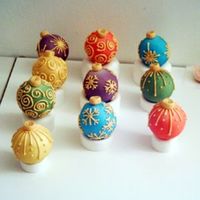 Chritsmas Ornaments More christmas ornaments, these are made with the ball pan then sandwiched together with bc. Covered in fondant and details in RI. Sorry...