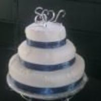My First Actual Wedding Cake. Covered with fondant and decorated with fondant snowflakes and blue ribbon.