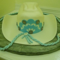 Cowgirl Hat Cake I made for this years Central Florida Fair. Front decoration and band were made out of gum paste and cut with my Silhouette.