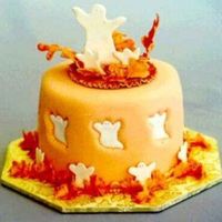 Halloween Cake Of Happy Ghosts Rolled fondant covered cake with a gum paste topper. The cookie cutter has been pressed into the fondant and the orange ghost removed. Then...