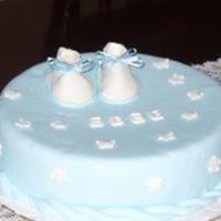 Botitas.jpg This is my first cake for a Baby shower. Vanilla taste, cover with fondant. Booties and flowermade of Pastillaje