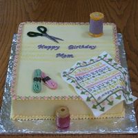 Cross Stitch Sampler 11x15- 1/2 coconut w/ pineapple filling-1/2 choc. w/ raspberry. Fondadnt/gumpaste scissors, floss, 'wooden' spool of thread, and...