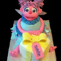Abby Cadabby Made for a friends daughter. Head is RKT covered in fondant and hair is royal. Body was carved from 2 8" and 1 6' cakes. Present...