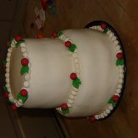 Christmas Cake yay! my First 2 teir cake! White cake coved in MMF. 8"-6" filled with butter cream icing. -Samantha (age 15)
