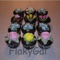 Floralcupcakes.jpg Chocolate cupcakes with chocolate ganache frosting. Flowers are buttercream. Made for a friend's birthday