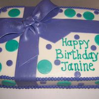 Gift Cake White cake with buttercream icing, Purple fondant bow with purple and teal fondant dots.
