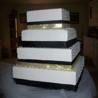 100_0846.jpg The Bride wanted a simple square cake covered in white fondant and with RI dots, The dots took forever!