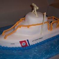 Uscg 41' Almond scented white cake with buttercream and MMF. MMF accents and edible images for USCG logo. White chocolate antenna thingies. There is...