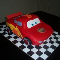 Lightning Mcqueen White Cake covered with MMF. Decorations are fondant and edible images.