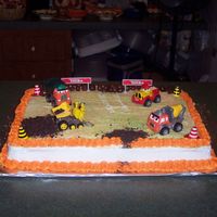 Construction Site This is a cake I did for a 2 year old. I used brown sugar, crushed cookies, and crushed gram crakers for dirt. I used bridge mix for rocks...