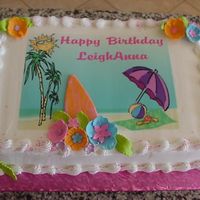 Luau Birthday Sheet cake made to match the paper party plates. It is a combination of an edible image and MMF for the flowers and surfboard.