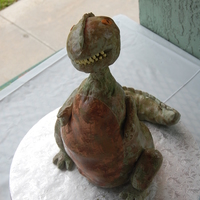 Another Day, Another Diinosaur My 6 yo son loves dinosaurs. This is the second dinosaur birthday he's had. French vanilla cake, rkt and fondant.