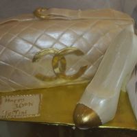 Chanel Purse And Shoe The cake was done with white chocolate fondant and the shoe is solid white chocolate. Both were highlighted with luster dust