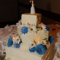 1St Wedding Cake Three tiered square wedding cake. French vanilla with raspberry filling(bottom), chocolate with fudge filling(middle), Marble with Fudge...