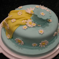 Teal Daisy Fondant Cake This is not my first fondant cake but I still learn something every time. This is a marble cake covered with teal MMF. Daisies are gumpaste...