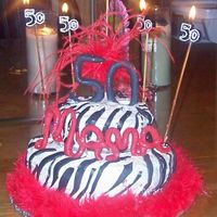 Mamas 50Th Birthday red velvet cake..... first time ever working with fondant and 2 tier. I think i did pretty good for a beginner!! Enjoy