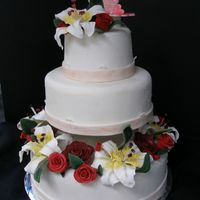 My First Wedding Cake! It's rolled fondant, with fondant Flowers. The flowers took me 6 days to make!