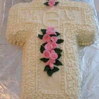 Christening Cross Cake Covered in white buttercream and embellished with fondant roses.