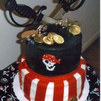 Skulls And Bones STACKED ROUND CAKES, BC ICING, RED FONDANT STRIPES, AIR BRUSH BLACK, SKULL TOMATCH MATERIAL COVERED BOARD, CHOC. COINS, DOLLAR STORE SWORDS...