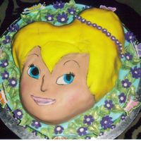 Tinker Bell Again SHAPED PAN ON ROUND CAKE COVERED IN FONDANT, PAINTED EYES AND MOUTH,FONDANT FLOWER, FONDANT LEAVES BRUSHED WITH GREEN LUSTER DUST,...