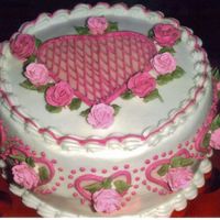 Baby Roses And Hearts ROUND CAKE COVERED IN BC, ROYAL ICING USED FOR STRINGWORK ON CENTERHEART AND ROSES DONE IN ROYAL AND MINI CHOC. KISSES, HEARTS AROUND...