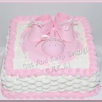 Rattle & Roll 12" Lemon square with cheesecake mousse filling. Booties and rattle (RKT) made with fondant. Rattle has pearl & silver dragees.