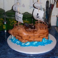 Pirate Ship Chocolate fudge cake with BC and MMF. Cannon, treasure chest and railing were done with a MMF/modeling chocolate mixture. TFL!