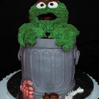 Oscar The Grouch I borrowed this design from button moon on CC. I used three 6"x2" cake for the can. I sculpted the arms and hands from rice...