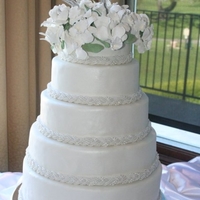 Pearl Cake This cake is 5 tiers of white cake with cream cheese filling. Covered in fondant and sprayed with pearl.