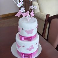 Pink Butterfly Cake For Christening Covered in fondant. Was worried about covering the cakes because they were so tall and had a bit of trouble rubbing the joins closed cause...