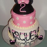 Pink And White Minnie Mouse Cake Cake is covered and decorated in fondantTop layer is strawberries and creambottom layer is chocolate cake with raspberry and grandmanier...