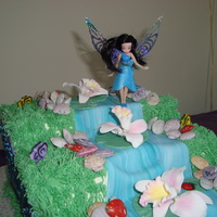 Silvermist This is a silvermist cakedecorated with fondant, buttercream, sugar flowers and chocolate rocks.The cake is yellow with strawberries