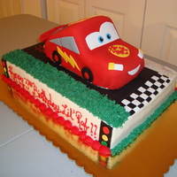 Lightning Mcqueen This cake is covered with fondantThe car is a marble cake with buttercreamand the bottom layer is yellow cake with amarretto bavarian.