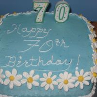 Birthday Cake Made this for my mother in law's...well....70th! :) White cake with strawberry buttercream filling and BC with royal icing daisies....
