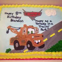 Mater From Cars Movie Mater and Cars logo are color transfers made with royal icing. Everything else is buttercream.