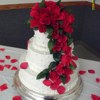 Kelly's Rose Cascade 6, 10, 14 inch cakes. Almond flavor buttercream icing with edible pearls. Silk roses.