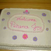 Baby Shower This is a half sheet cake with buttercream icing. The flowers are made with royal icing and I striped the bag for the daisies. The oval...