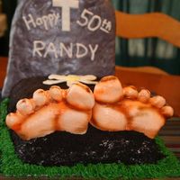 Over The Hill This is a 1/4 sheet cake rounded with buttercream covered in crushed oreoa.The feet are made of MMF and airbrushed.The headstone is RK...