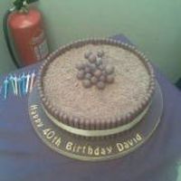 Chocolate Cake Chcolate sponge, fingers round the edge, grated chocolate on top with malteasers.