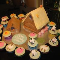 Barnyard Family My 2nd attempt at doing a barn cake. saw these cute little cow toys and decided to make some for the cupcakes.