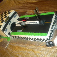 Drag Strip For 60Th Birthday Cake is done with all B.C. and fondant accents. Building and track fudge and french vanilla cake. Edible images for the decals