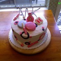 Cake Done For Mary Kay Party Everything is edible except the pearl letters on top. The make-up is made of chocolate, and the polkadots are fondant.