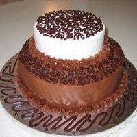 Birthday Cake French Vanilla Cake covered in Chocolate Buttercream and White Buttercream Frosting Filled with Chocolate Ganache. Attempted Ganache piping...