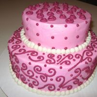 Scrolls Pick and Dark Pink Buttercream Icing. Chocolate Fudge Cake with Ganace Filling