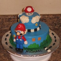 Mario Kart 8", 4" rounds. Mario & mushroom made of fondant.