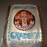 Grade 7 Grad Chocolate cake with Twinkie filling. Buttercream frosting. Holy Cross emblem made out of fondant.