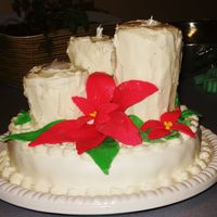 Pointsettia Cake Fruit cake base with MMF. Candles are gingerbread cake with creamcheese icing. Pointsettia and holly leaves are MMF