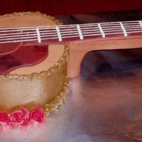 Accoustic Guitar Accoustic guitar cake for a young lady who wanted red roses added to the design. Guitar body was chocolate cake filled with whipped...