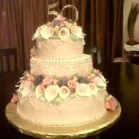 50Th Anniversary Flowers Pastell roses and leaves on two tiers of chocolate and one tier of french vanilla. I was 2 weeks shaping, drying and painting flowers, but...